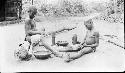 Two boys putting poison on arrows