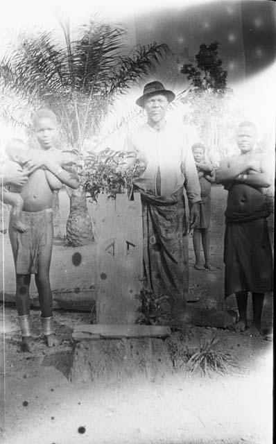 Family standing around decorated medicine board seat