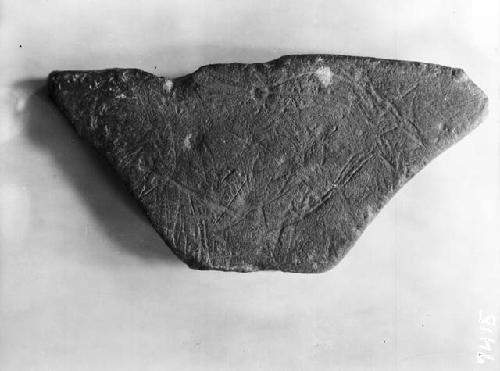 Engraved trapezoidal shaped stone first face