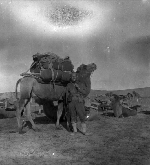 Lattimore standing in front of loaded camel