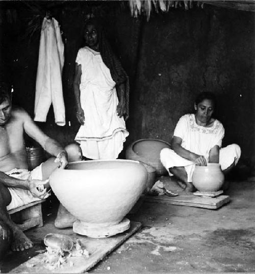 Modern pottery making - resting on a kabal which in turned by the hands or feet