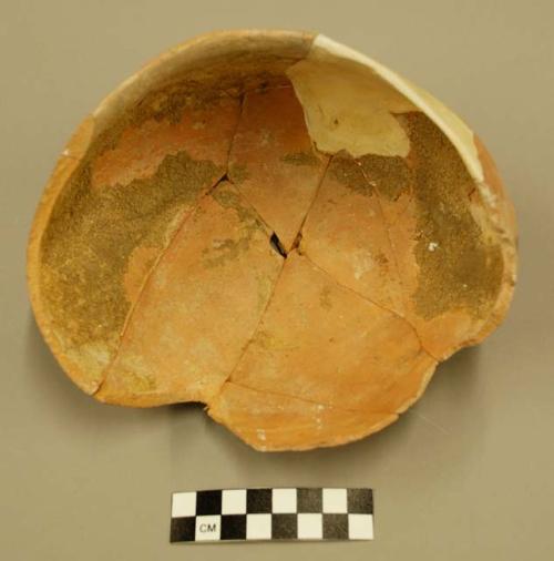 Restored pottery bowl containing substance