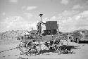 Elwood Dennis loading a stove on the wagon