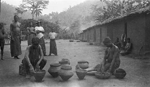 Women making clay pots, showing process