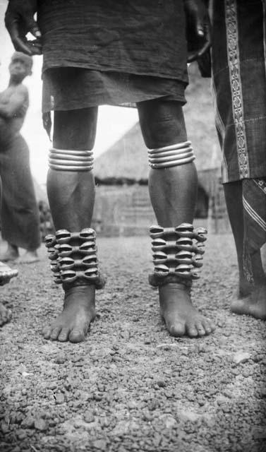 Person wearing large brass anklets and leg calf ornaments