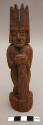 Carved wooden figure - human, trident headdress; grasping stick with +