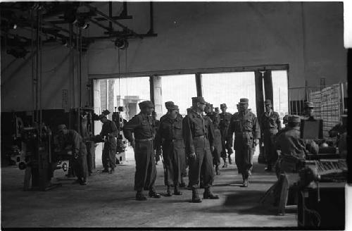 Military personnel in a warehouse