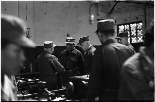 Military personnel in a machine room