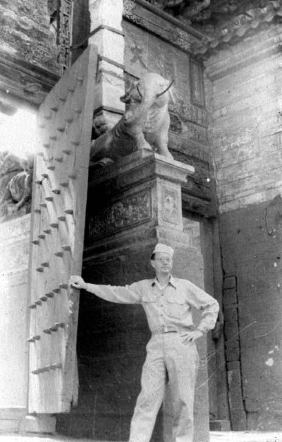 Man standing by large door