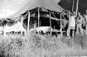 Men in front of tent