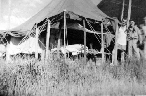 Men in front of tent