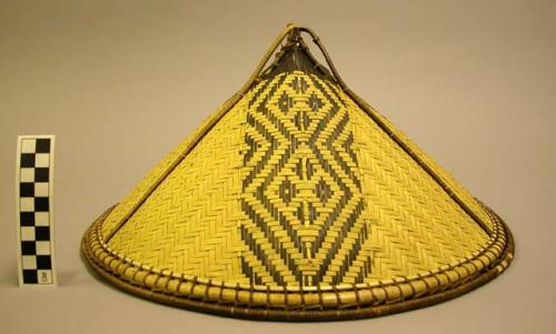 Woven hat with three vertical panels, looped finial