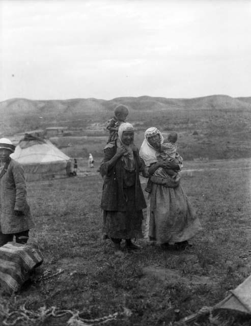 Two Kazak women, both holding small children