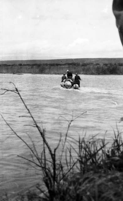 Crossing Tekes, three men on pack horses fording river