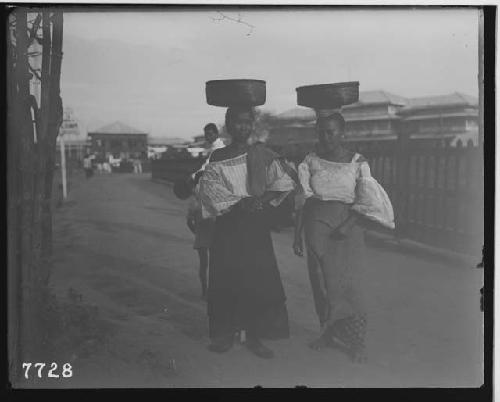 Girls carrying baskets