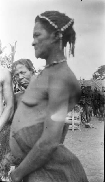 Native woman with hair decoration possible cowry shells, earrrings and necklace