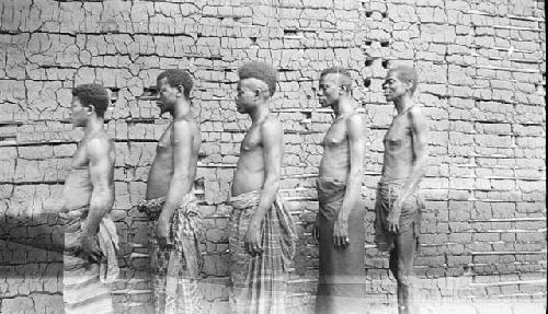 Men in front of brick building