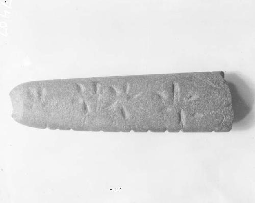 Bone engraved with six pointed starburst patterns