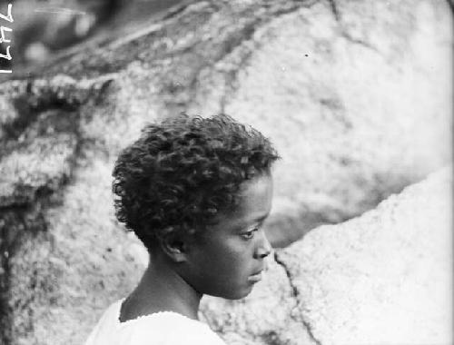 Profile view of mixed race child with curly hair