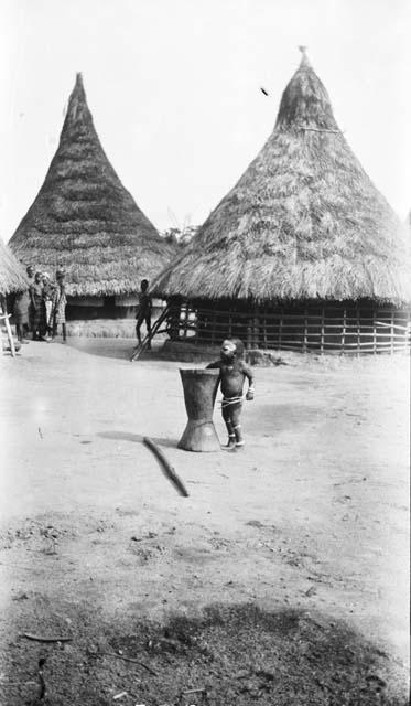 Young child learning to use mortar and pestle