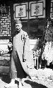 Man standing in front of a building wearing long robe and cap