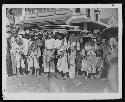 Group of children and men in road