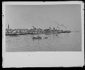 Boats on water next to landscape