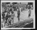 Men and children standing on dock