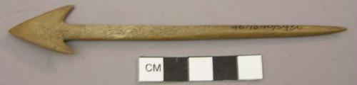 One carved animal bone with arrow-head. Bone instrument with arrowhead.