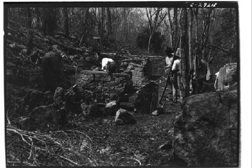 Workers standing around fragments of stelae