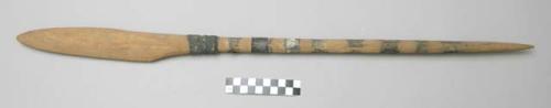 Wooden digging stick with silver around shaft