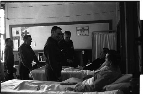 Men lying in hospital beds