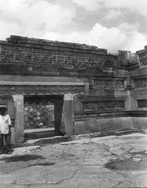 Mitla ruin - man under mosaic wall