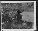 Child seated in jungle