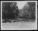 Men putting boats in water