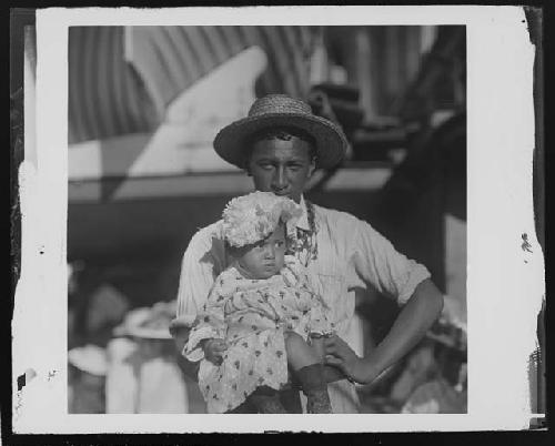 Man and baby wearing hats