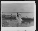Man in water with boats