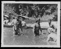 Men in Water with Boats