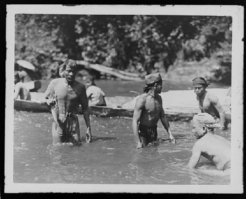 Men in Water with Boats