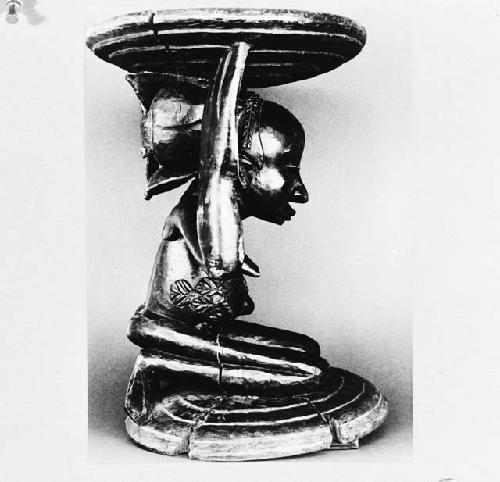 Stool with carved, kneeling figure