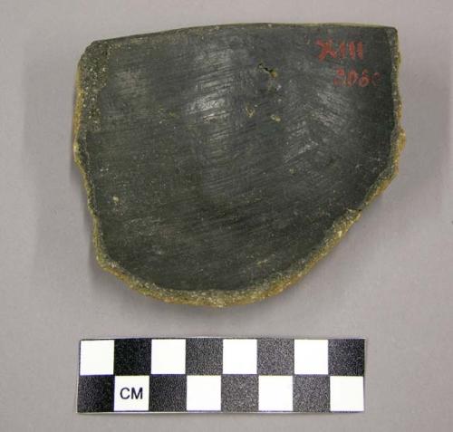 Pot rim sherd with plain red slip exterior, black slip interior