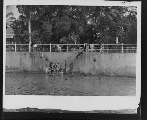 People on causeway along water