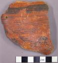 Black on red wall sherd with band and triangle stripe design