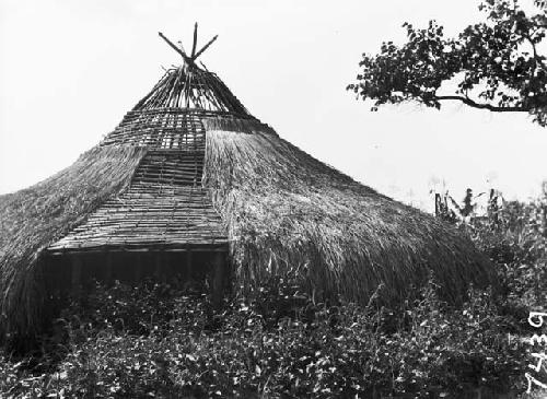 Partially constructed hut with part of roof exposed