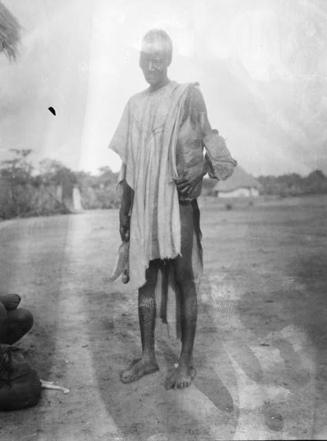 Male farm cutter with blade and bag slung over shoulder