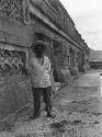 Custodian in front of room series overlooking corridor