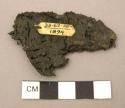 Sandal fragment, charred cloth