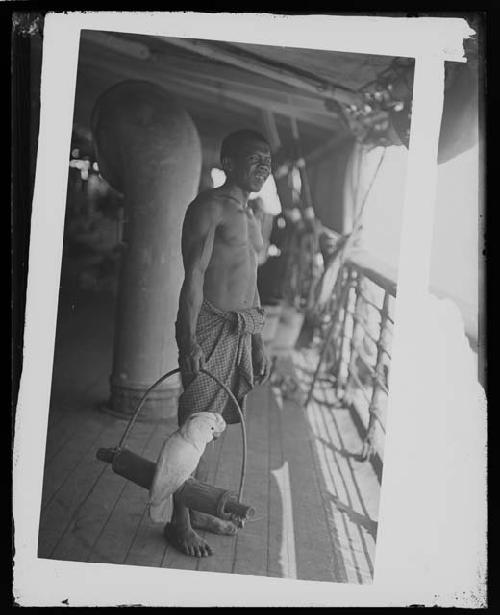 Man on boat deck with bird