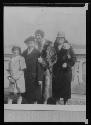 Two women and two children in front of facade