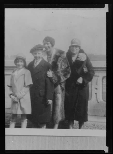 Two women and two children in front of facade